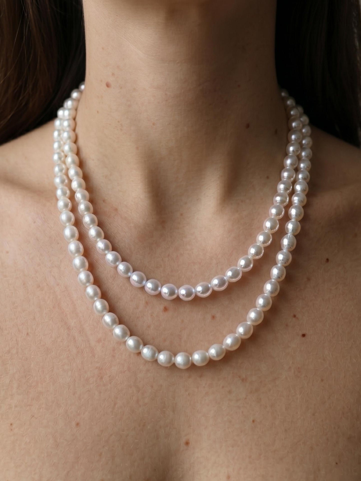 Elegant Pearltide round pearl jewelry strand doubled up for a layered look, embodying a quiet luxury aesthetic and timeless pearl jewelry design.