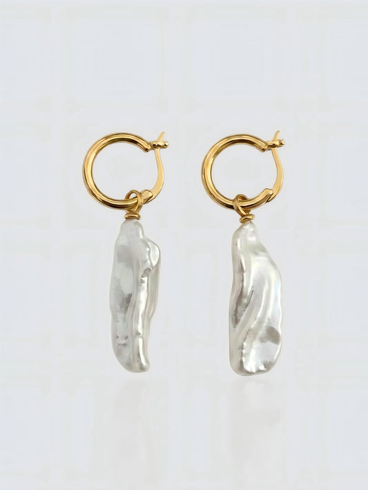 Elegantes pendientes dorados que destacan la belleza única de las perlas Keshi en forma de 'pétalo de mar', un diseño inspirado en la naturaleza.