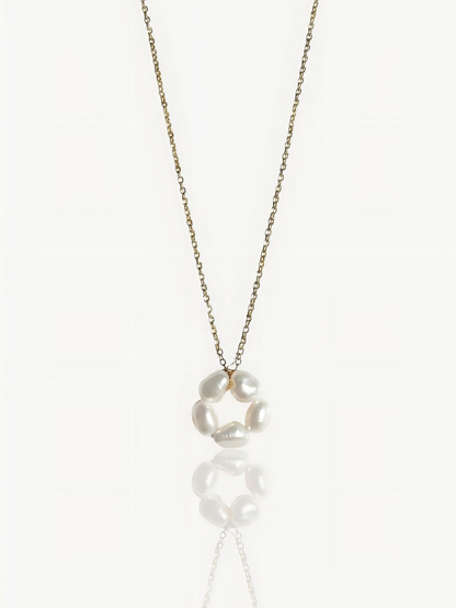 Close-up product shot of Pearltide’s minimalist petal baroque pearl pendant necklace, showcasing a high-luster sculptural pearl on a dainty 14K gold-filled chain against a clean white background. Elegant wedding and everyday statement jewelry.