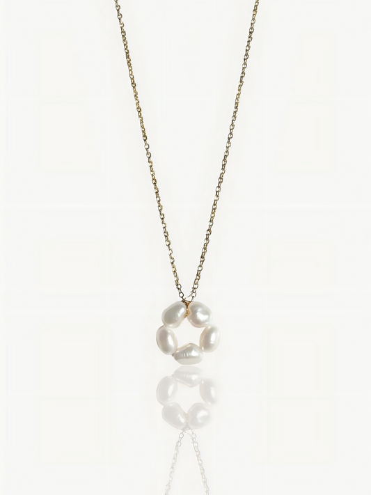 Close-up product shot of Pearltide’s minimalist petal baroque pearl pendant necklace, showcasing a high-luster sculptural pearl on a dainty 14K gold-filled chain against a clean white background. Elegant wedding and everyday statement jewelry.