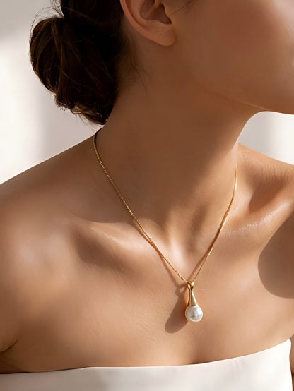 Close-up of a bride wearing a minimalist teardrop pearl pendant necklace, quiet luxury wedding aesthetic with sun-drenched lighting.