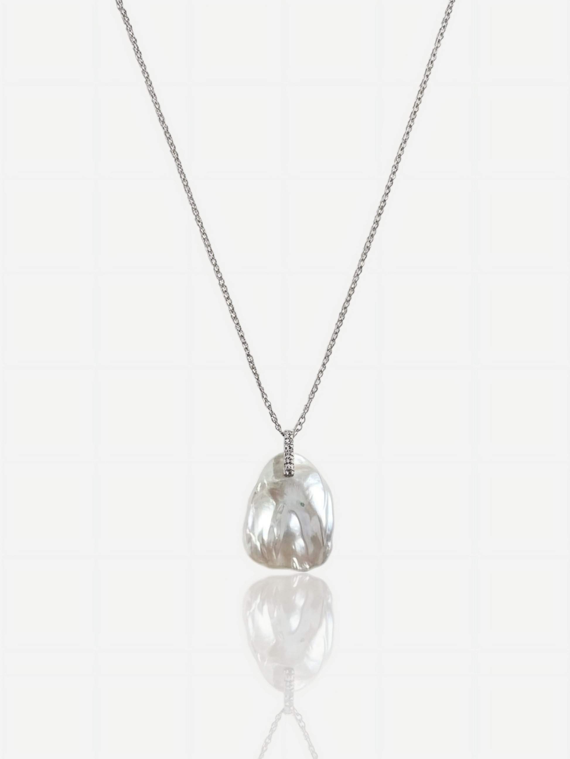 High-luster petal baroque pearl pendant necklace with diamond-accented bail on S925 sterling silver chain, elegant minimalist wedding jewelry for modern brides.