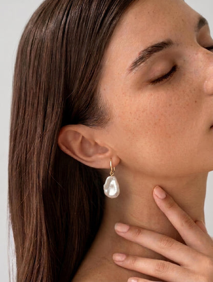 Elegant model shot featuring large baroque pearl earrings, styled for a minimalist wedding look with clean girl aesthetic and soft lighting.