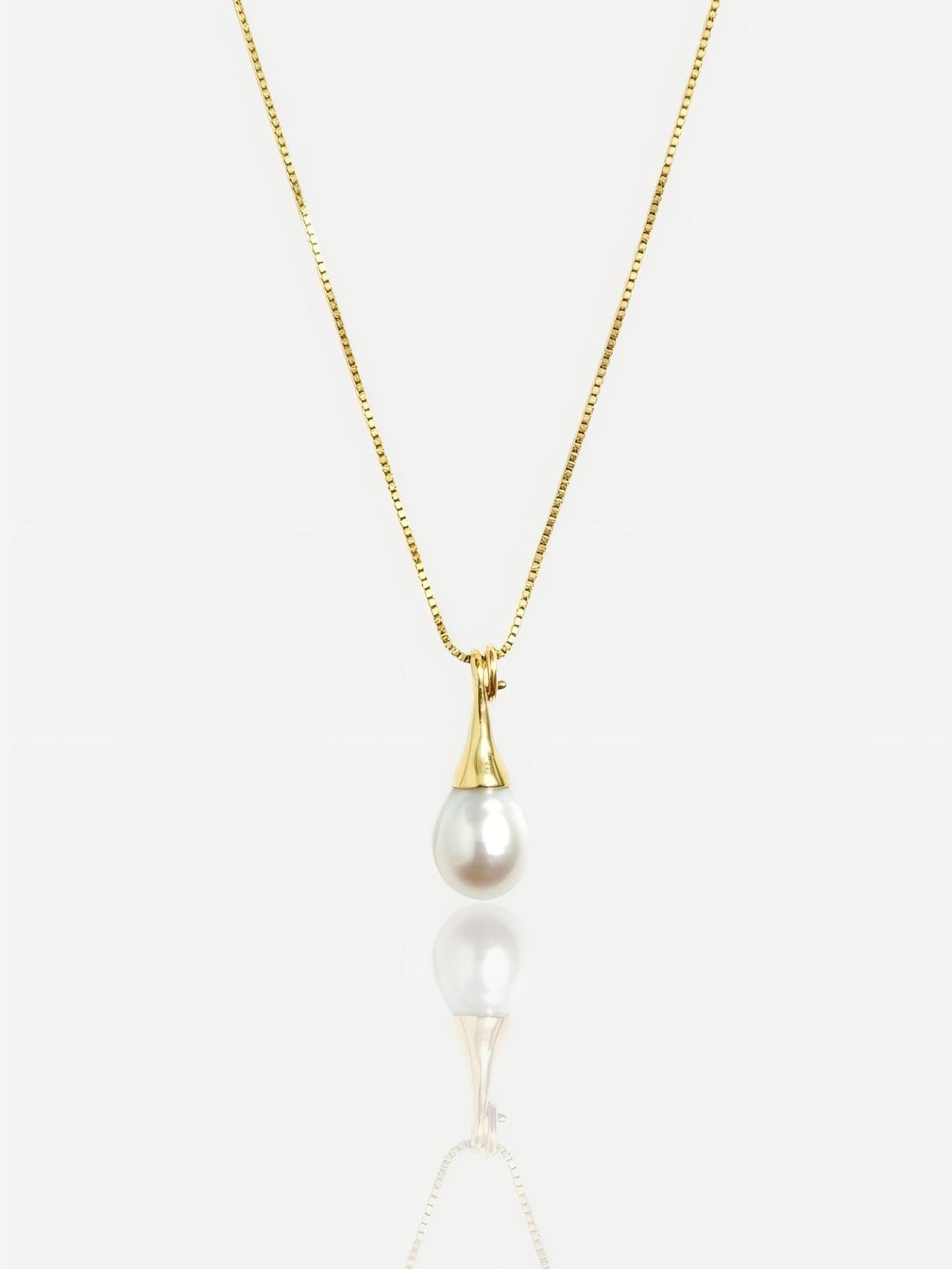 Close-up of Pearltide sleek teardrop pearl pendant with a modern tapered gold bail on a 14K gold-filled box chain, high-luster minimalist bridal jewelry.