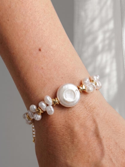 Model with glowing tan skin wearing a Pearltide mixed pearl statement bracelet, perfect for a quiet luxury resort look and sun-kissed vacation aesthetic.