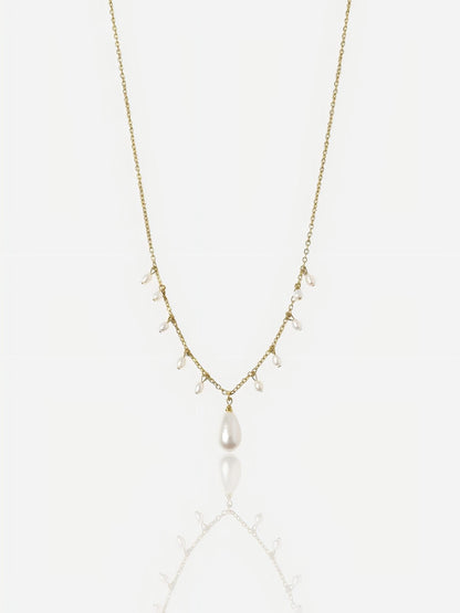 Close-up of Pearltide Moonlit Cascade necklace featuring multiple small rice pearls and a teardrop pendant on a 14K gold-filled chain, minimalist high-luster wedding jewelry.