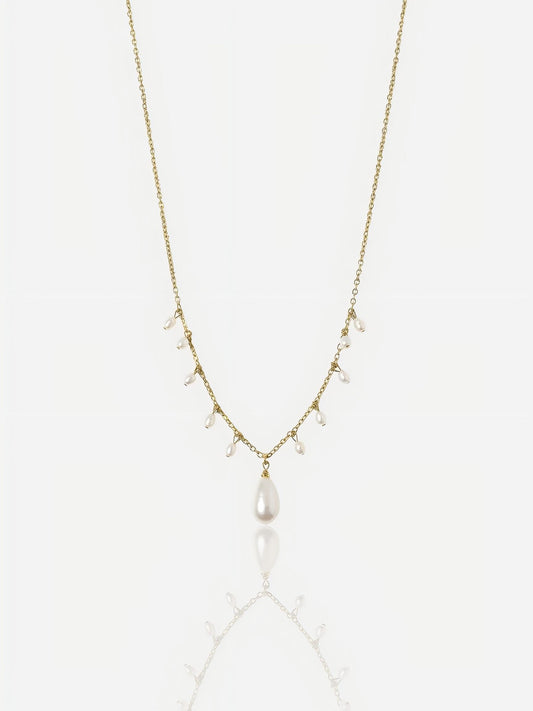 Close-up of Pearltide Moonlit Cascade necklace featuring multiple small rice pearls and a teardrop pendant on a 14K gold-filled chain, minimalist high-luster wedding jewelry.