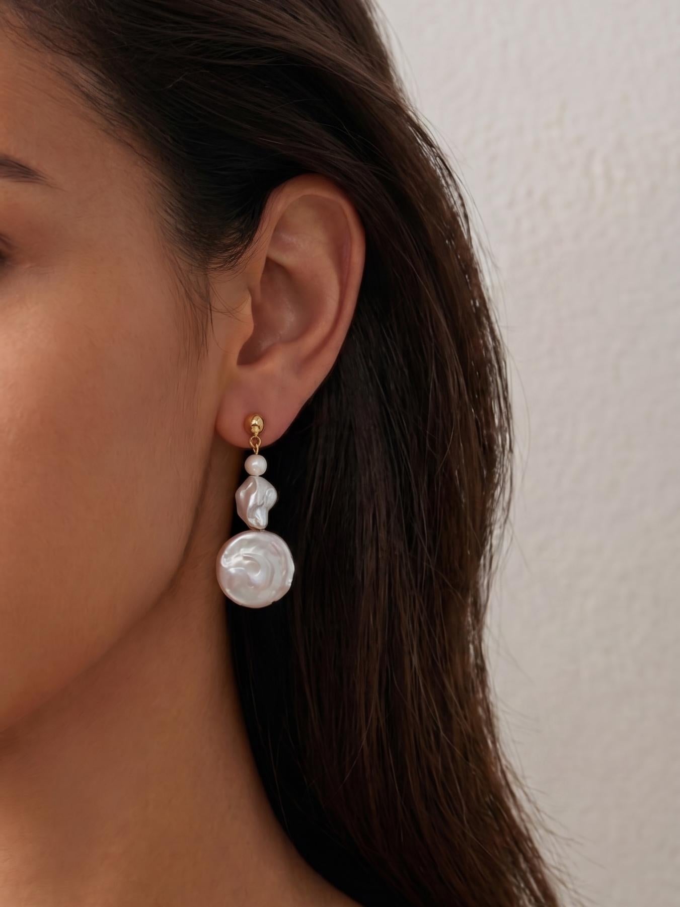 Model with tan skin wearing Pearltide sculptural triple-tiered baroque pearl earrings, sophisticated statement jewelry for modern brides and clean girl aesthetic daily wear.