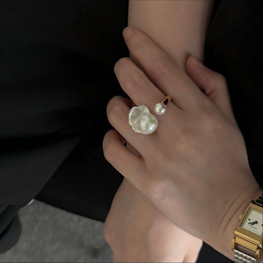 Close up of iridescent baroque pearl texture on a gold vermeil band.