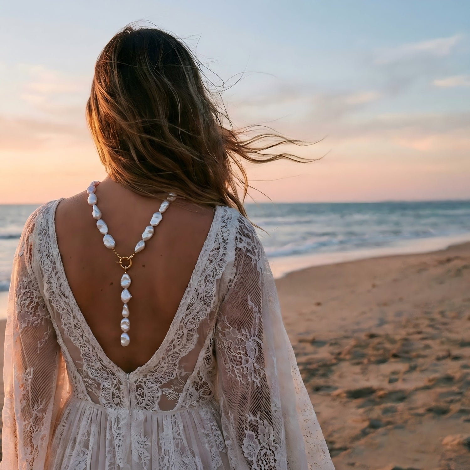 Back view of a bride at a beach wedding wearing a chunky baroque pearl necklace by Pearltide