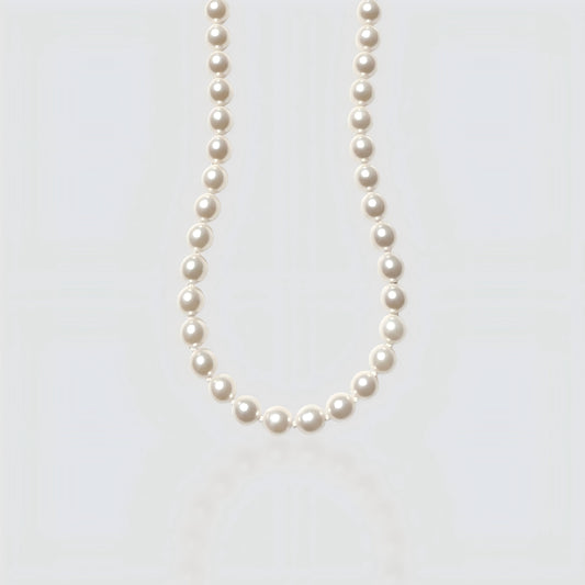 Studio shot of a large, metallic-luster Edison baroque pearl necklace on a neutral grey background.