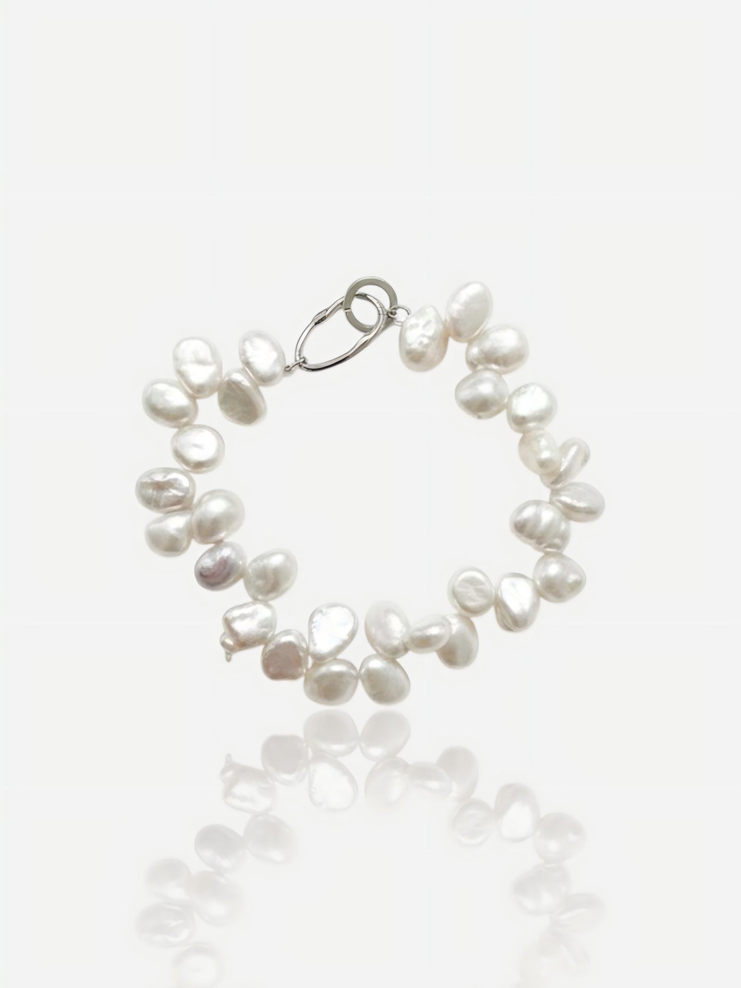 Close-up of Pearltide double-row organic Keshi pearl bracelet with a bold S925 sterling silver clasp on a clean white background, high-luster resort jewelry.