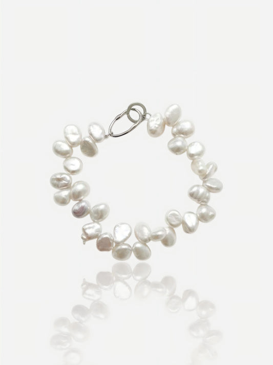 Close-up of Pearltide double-row organic Keshi pearl bracelet with a bold S925 sterling silver clasp on a clean white background, high-luster resort jewelry.