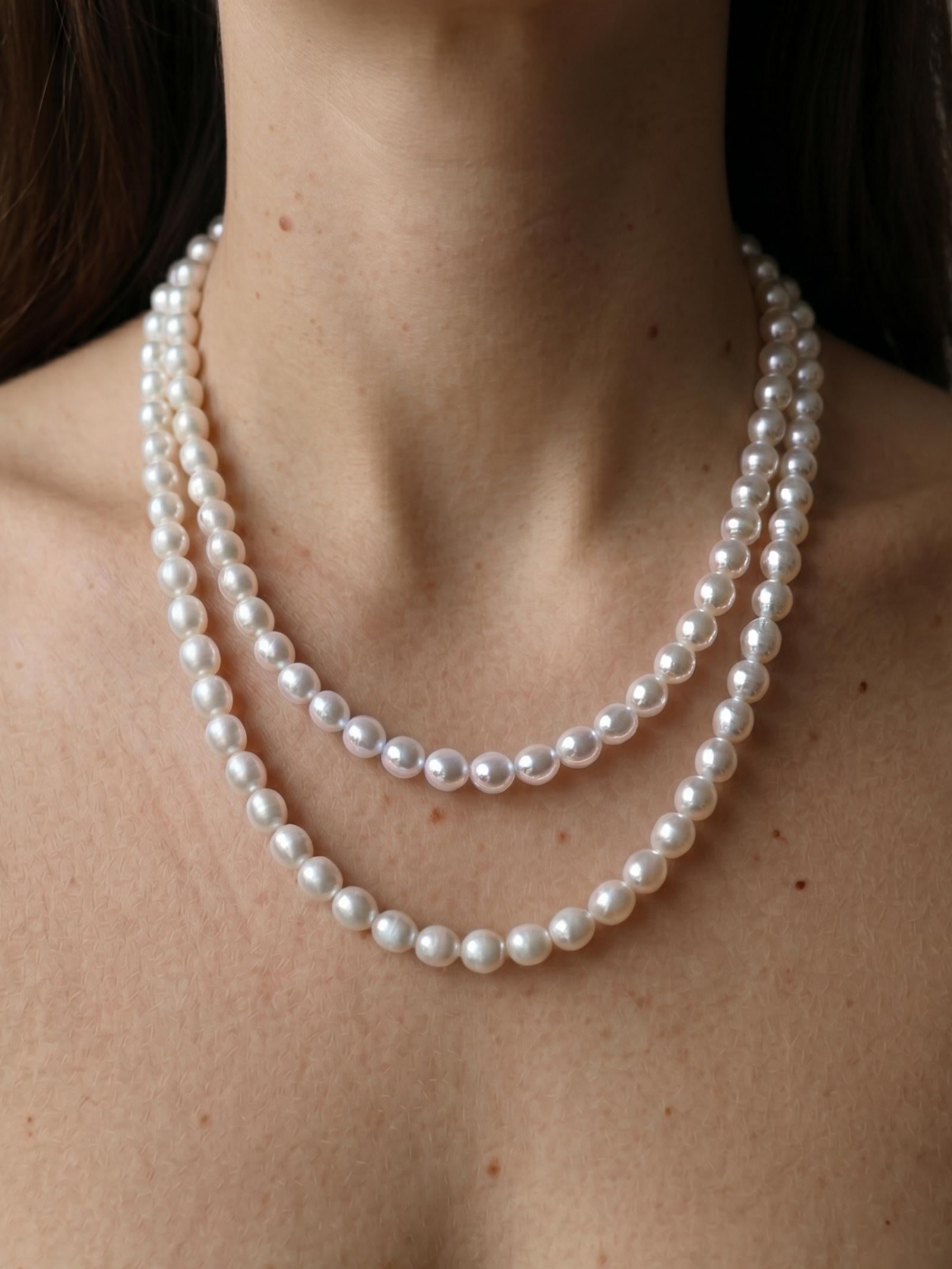 Elegant Pearltide round pearl jewelry strand doubled up for a layered look, embodying a quiet luxury aesthetic and timeless pearl jewelry design.