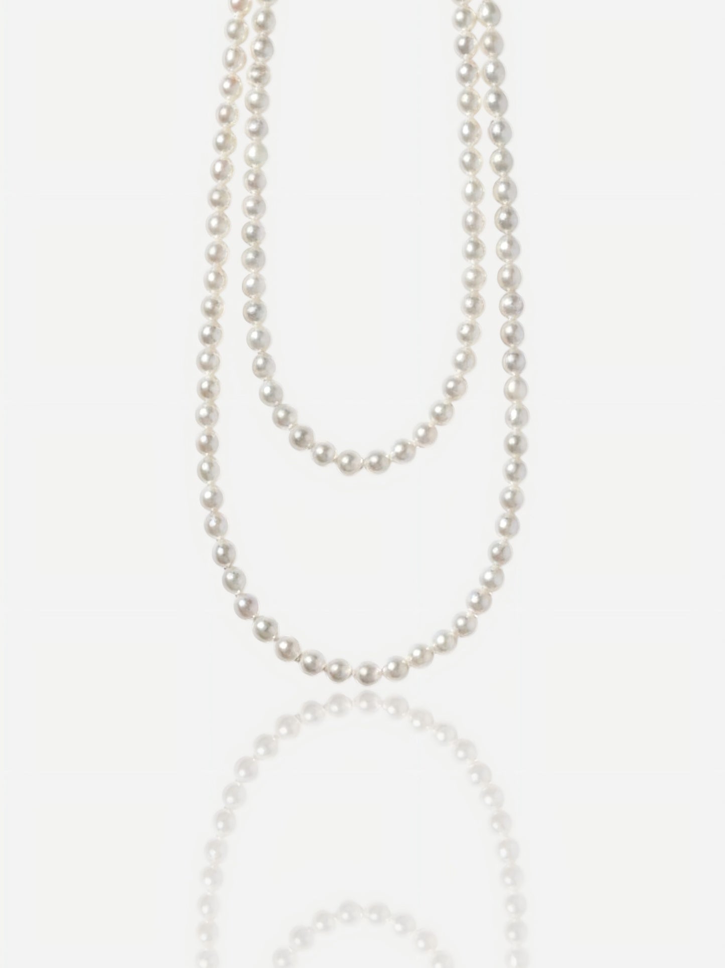 Close-up of Pearltide Eternal round pearl jewelry necklace with S925 sterling silver clasp on a white background, high-luster classic pearl jewelry for weddings.