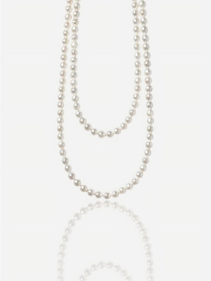 Close-up of Pearltide Eternal round pearl jewelry necklace with S925 sterling silver clasp on a white background, high-luster classic pearl jewelry for weddings.