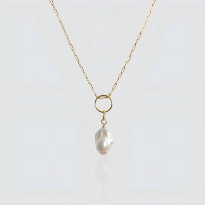 A striking balance between a statement baroque pearl and contemporary paperclip link chain.