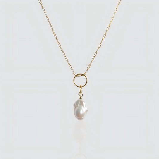 A striking balance between a statement baroque pearl and contemporary paperclip link chain.