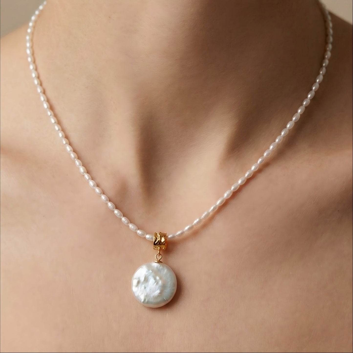 Sits perfectly at the collarbone. The tiny pearls offer a whisper of elegance, while the coin pendant adds a radiant glow to the skin.
