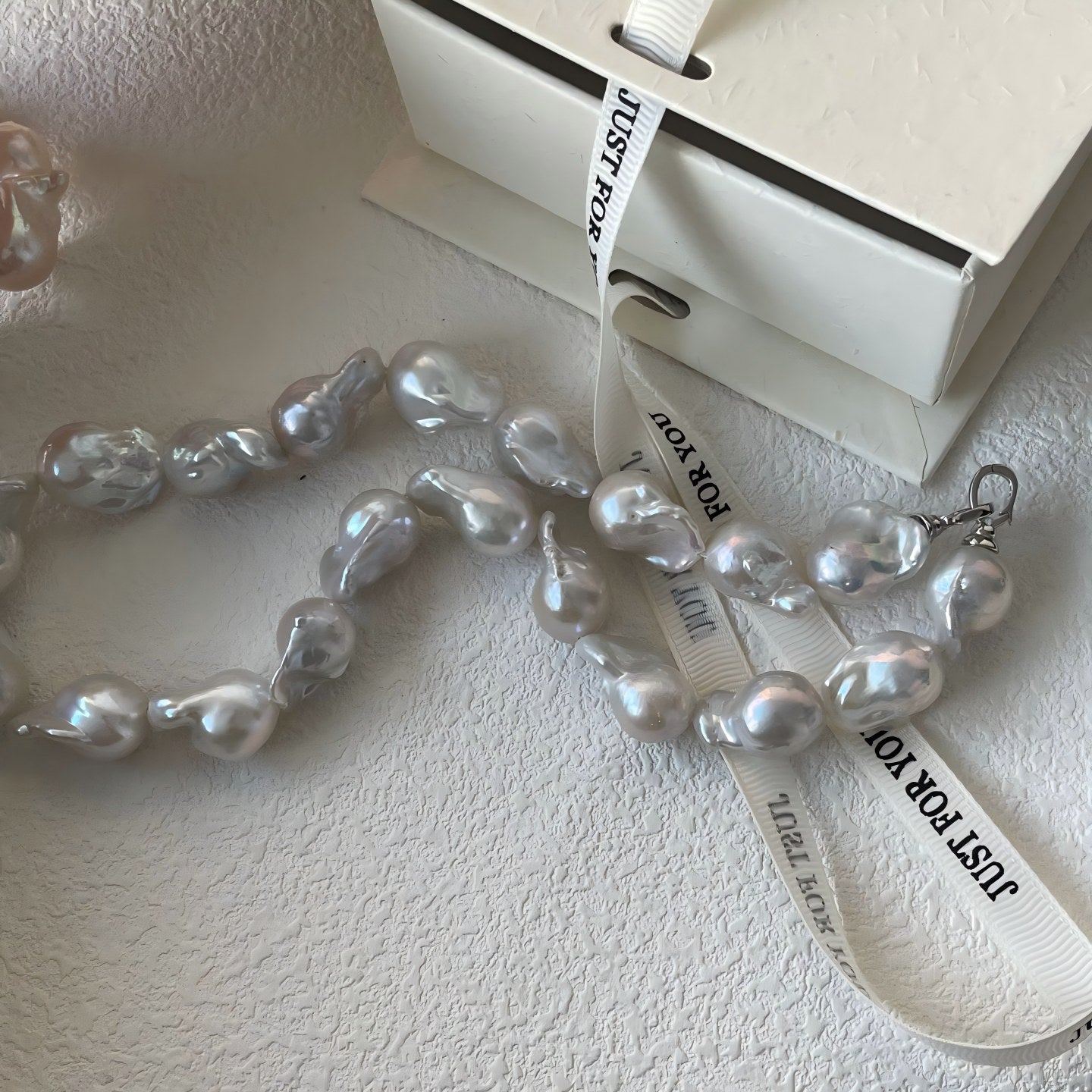 Close-up showing the stunning 'oil-painting' like texture and rainbow overtones on the pearl surface.