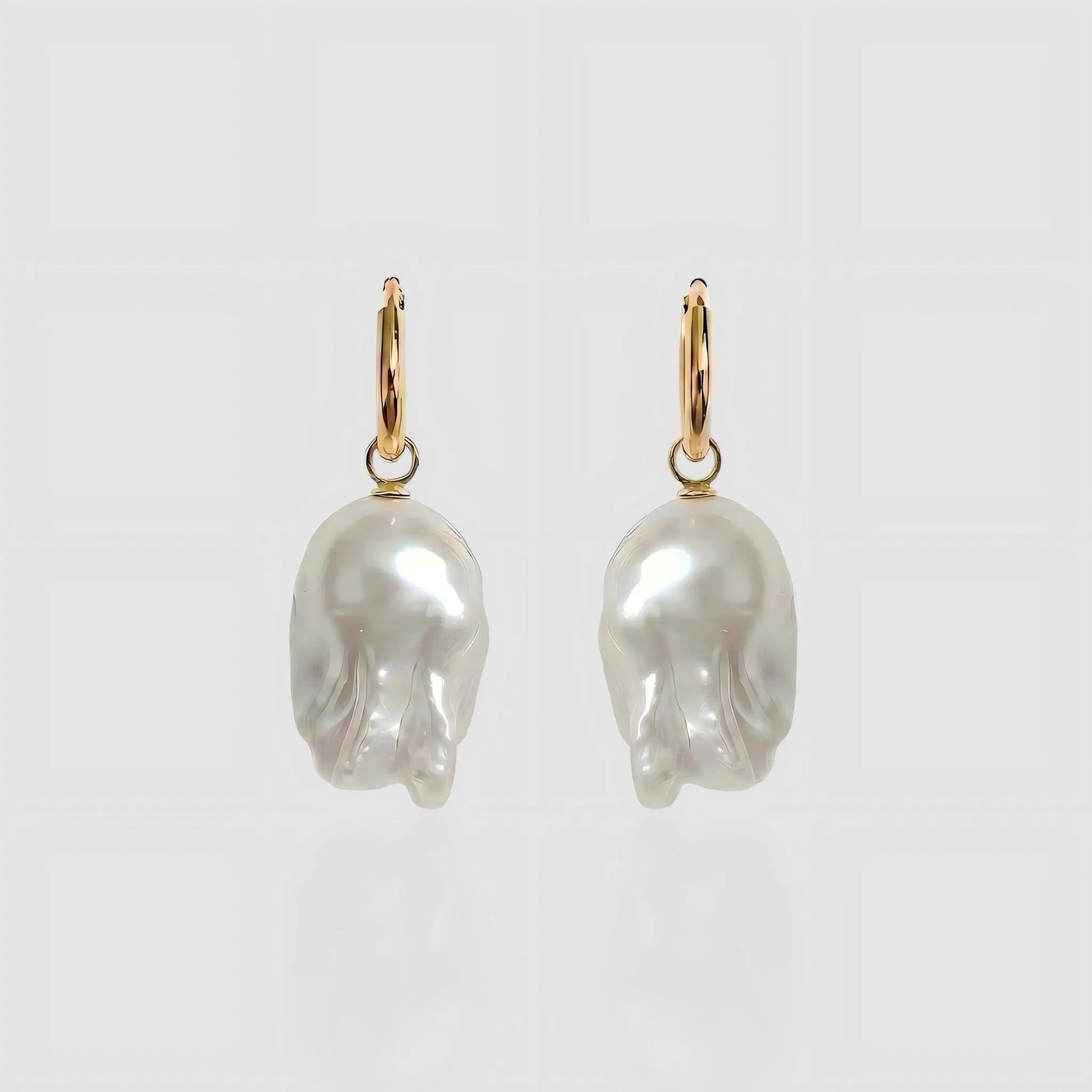 Pearltide The Aurora Drop earrings featuring genuine natural baroque pearls set in polished 18K gold plated metal, flat lay view.
