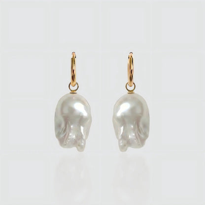 Pearltide The Aurora Drop earrings featuring genuine natural baroque pearls set in polished 18K gold plated metal, flat lay view.