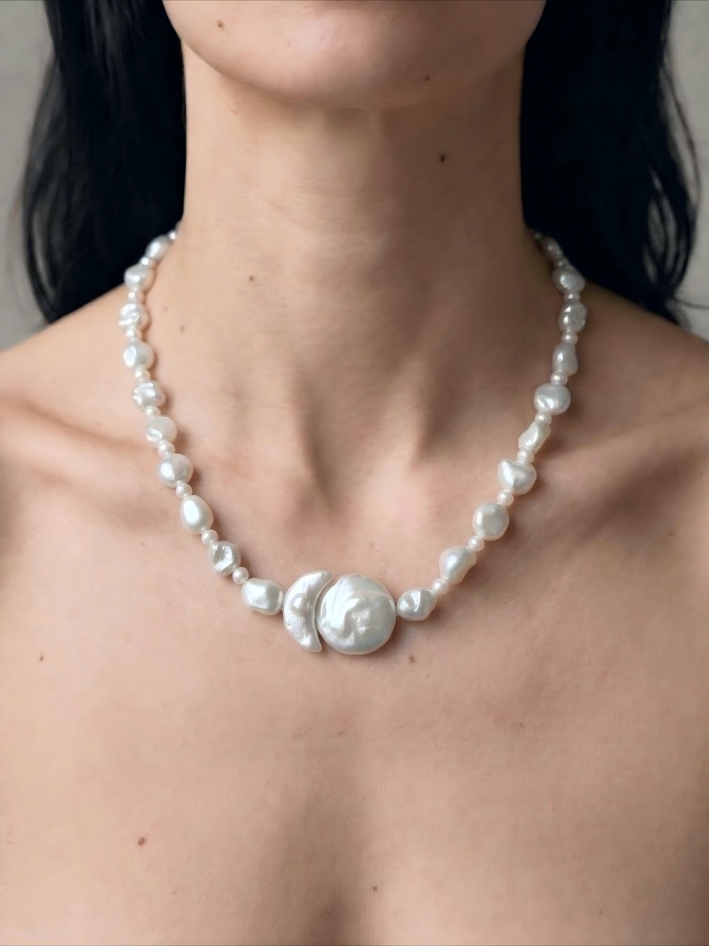 Minimalist styling of irregular baroque pearl choker necklace on collarbone, clean girl aesthetic jewelry styling.