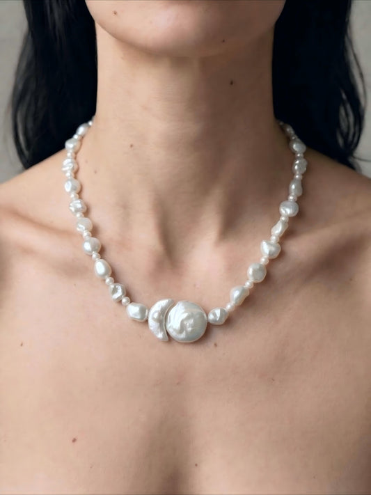 Minimalist styling of irregular baroque pearl choker necklace on collarbone, clean girl aesthetic jewelry styling.