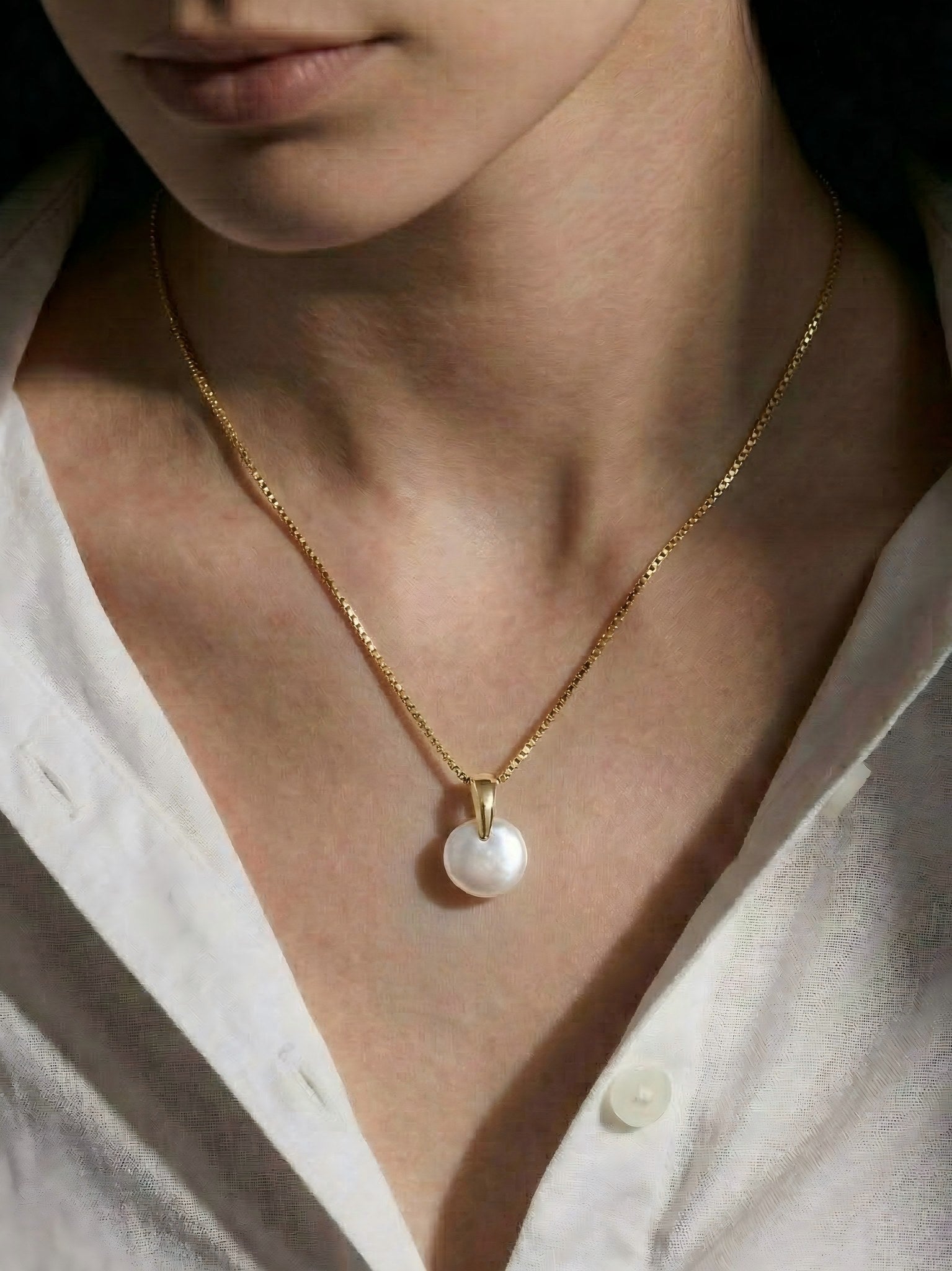 Woman wearing the Everyday Baroque Pearl Pendant with a casual white button-up shirt, versatile daily style.