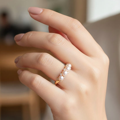 Elegant pink pearl cluster ring worn on a woman’s hand, showcasing the delicate scale and soft luster against a lifestyle background.