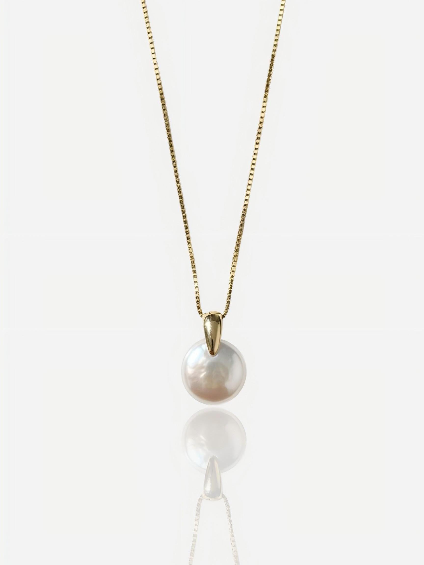 Close-up of Pearltide sleek lunar coin baroque pearl pendant with a modern tapered gold bail on a 14K gold-filled chain, high-luster minimalist bridal jewelry for a clean girl aesthetic.