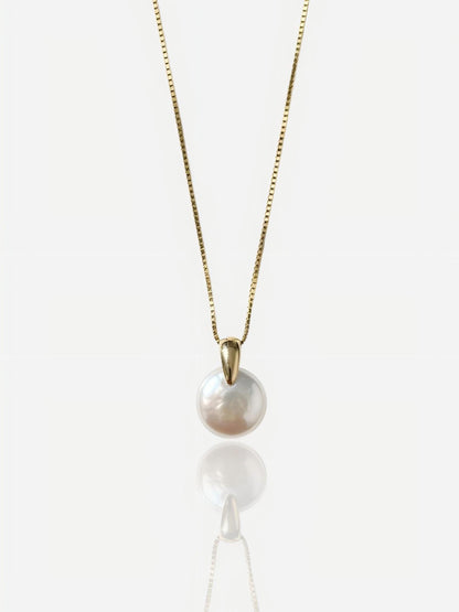 Close-up of Pearltide sleek lunar coin baroque pearl pendant with a modern tapered gold bail on a 14K gold-filled chain, high-luster minimalist bridal jewelry for a clean girl aesthetic.