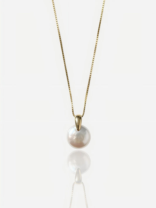 Close-up of Pearltide sleek lunar coin baroque pearl pendant with a modern tapered gold bail on a 14K gold-filled chain, high-luster minimalist bridal jewelry for a clean girl aesthetic.