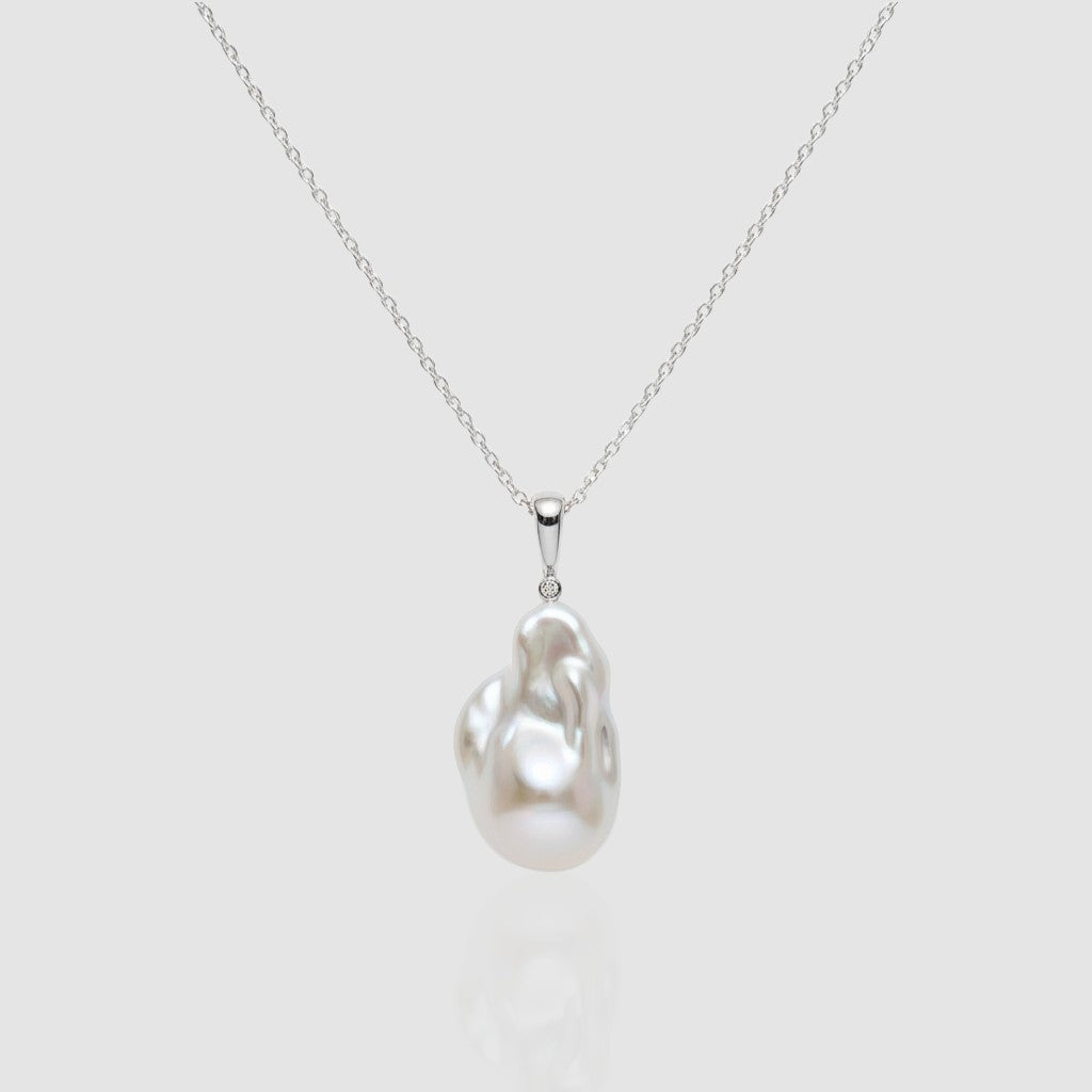 Single large white Baroque pearl pendant necklace on a silver chain, featuring a unique organic shape and high luster. Minimalist jewelry by Pearltide.