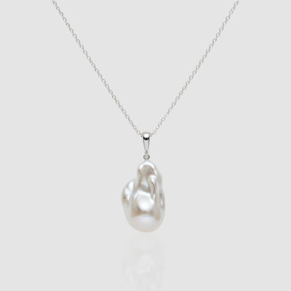 Single large white Baroque pearl pendant necklace on a silver chain, featuring a unique organic shape and high luster. Minimalist jewelry by Pearltide.