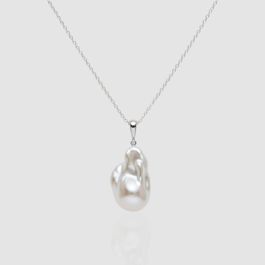 Single large white Baroque pearl pendant necklace on a silver chain, featuring a unique organic shape and high luster. Minimalist jewelry by Pearltide.