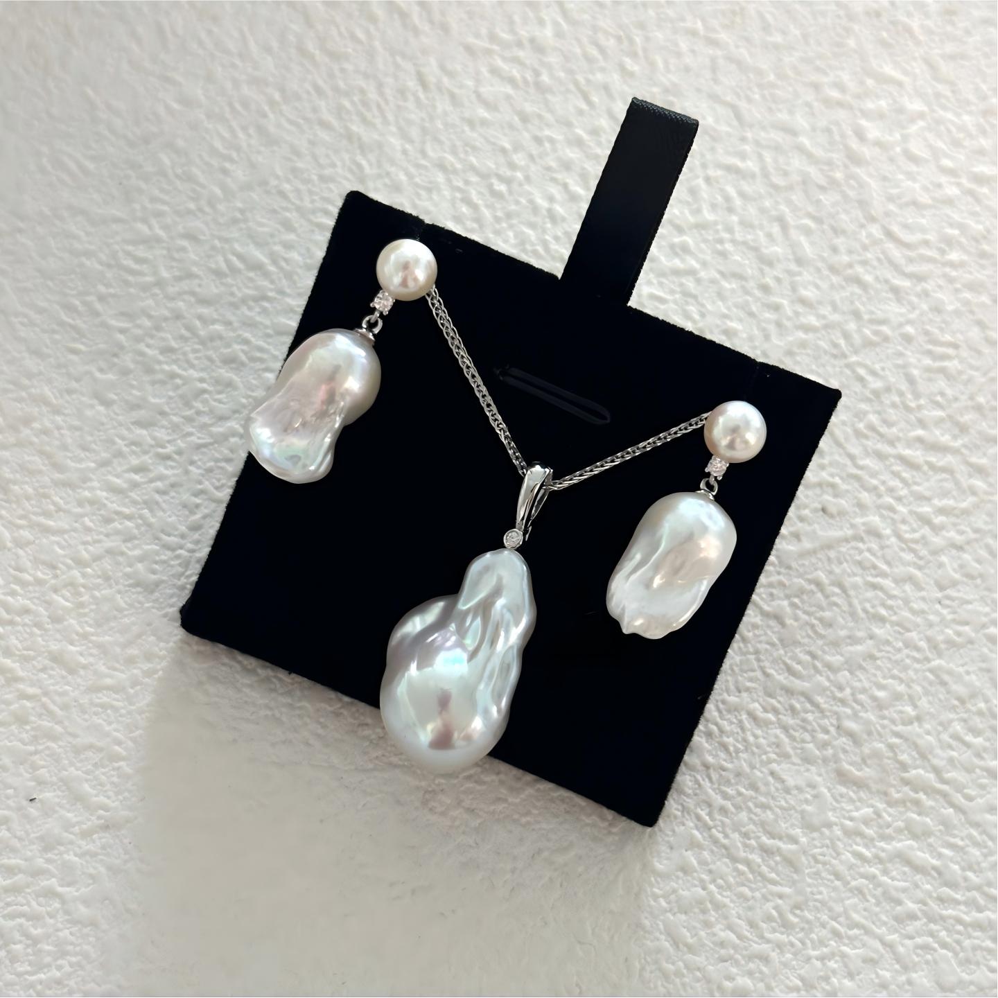 Macro shot of Baroque pearl texture showing natural iridescent ridges and a small diamond accent on the pendant bail. High-quality freshwater pearl detail.