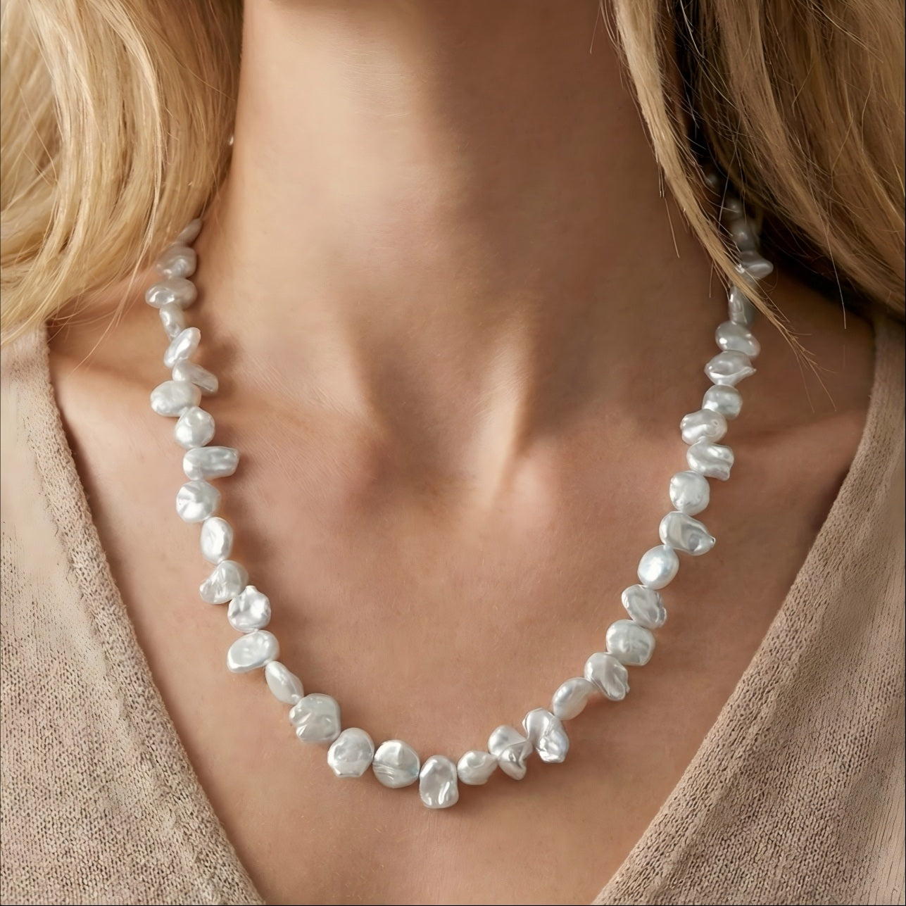 A model wearing the organic Keshi pearl necklace, highlighting the petal-like texture and shine against the skin.